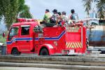 The local barangay fire brigade practices in the park